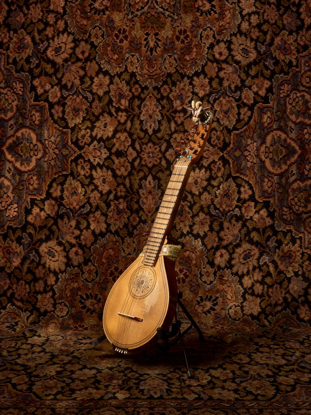A cittern with a goat carved into the headstock