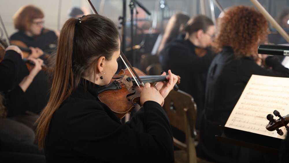 Recording a chamber string sample library in a Latvian church. Photo by Larissa Matheus. 