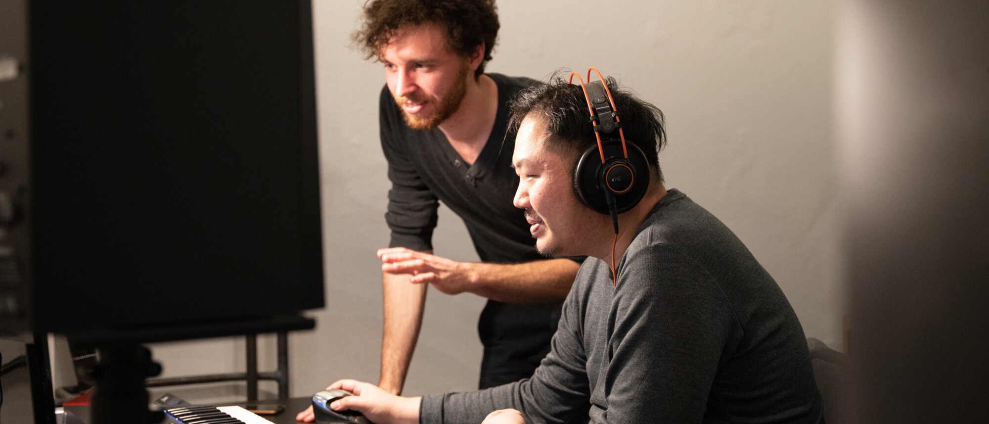 Two sound designers working at a computer
