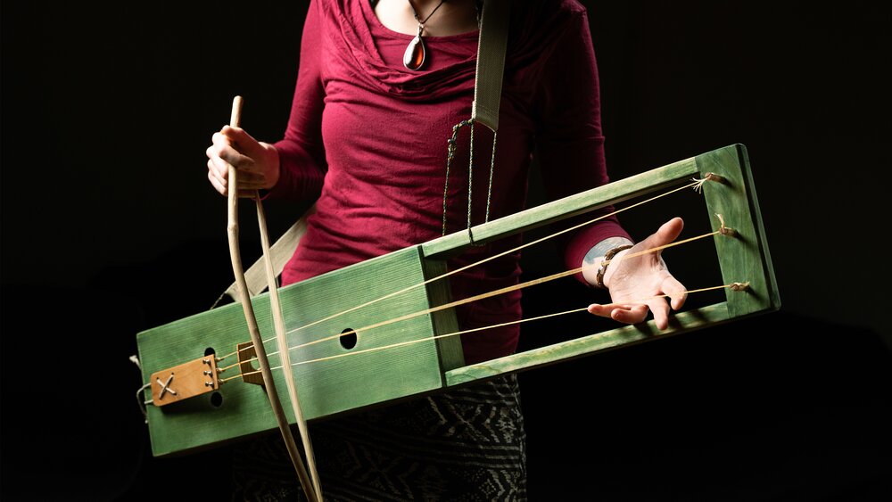 Close-up of a woman playing a tagelharpa cello