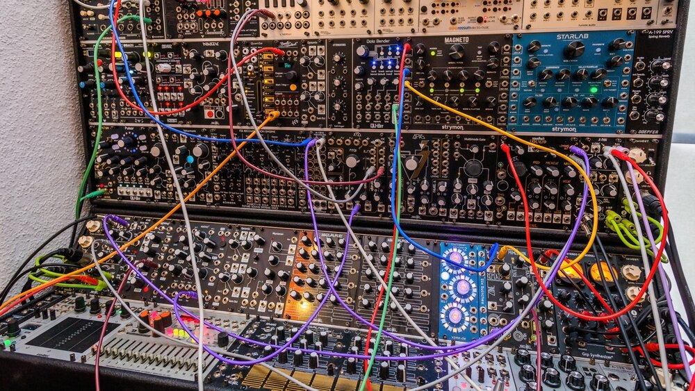 Enormous modular synth setup with complex and colorful wires