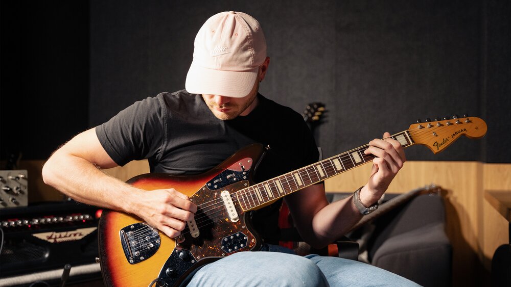 Cornelius Durst plays an electric guitar