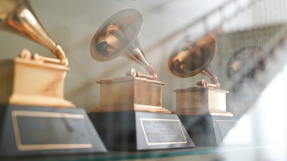 Several Grammy awards in a display case