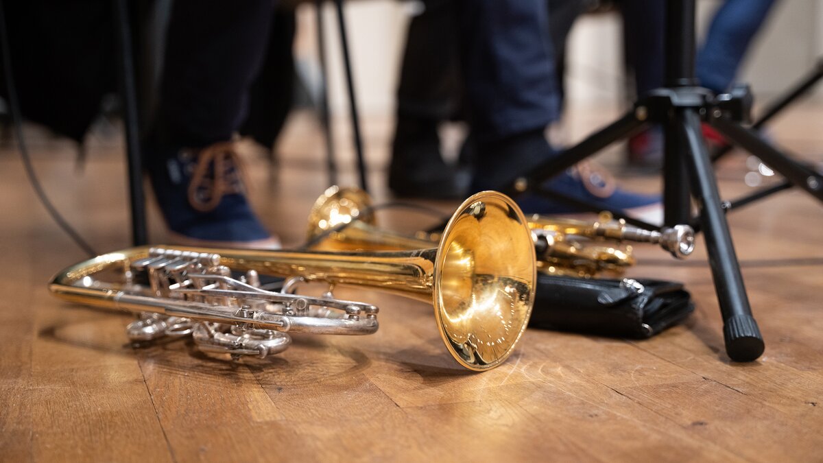 Brass instruments resting on a hardwood floor