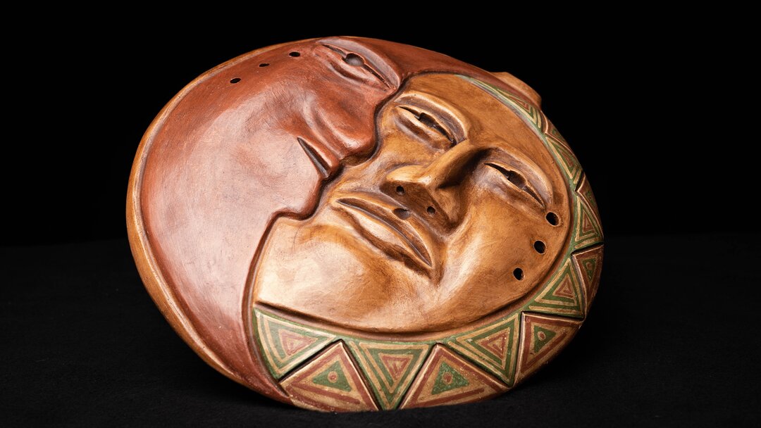 An ocarina with an image of a sun and moon on its face