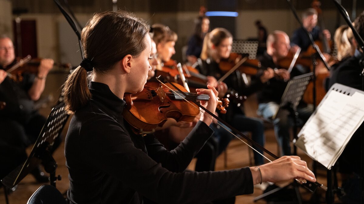 Violins performing con sordino for a sample library recording session