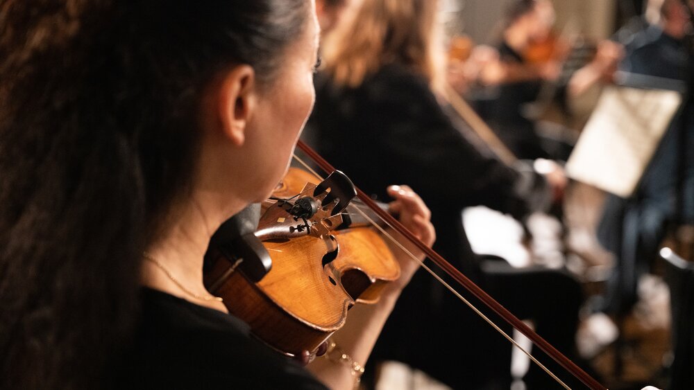 Violin player with con sordino mute