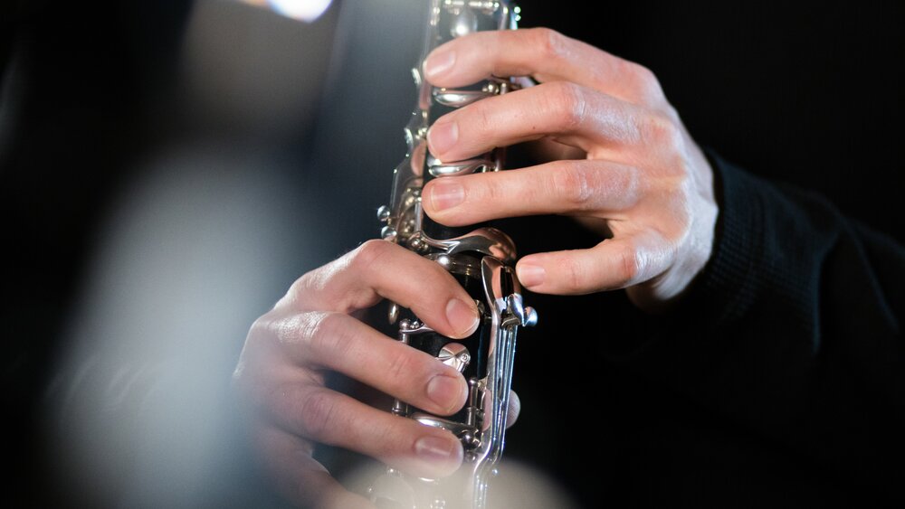 Close-up of hands on a clarinet. Photo by Robin Lambrecht.