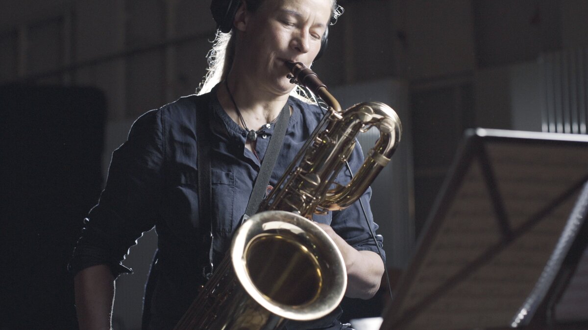 A saxophone player recording the big band horns sample library.