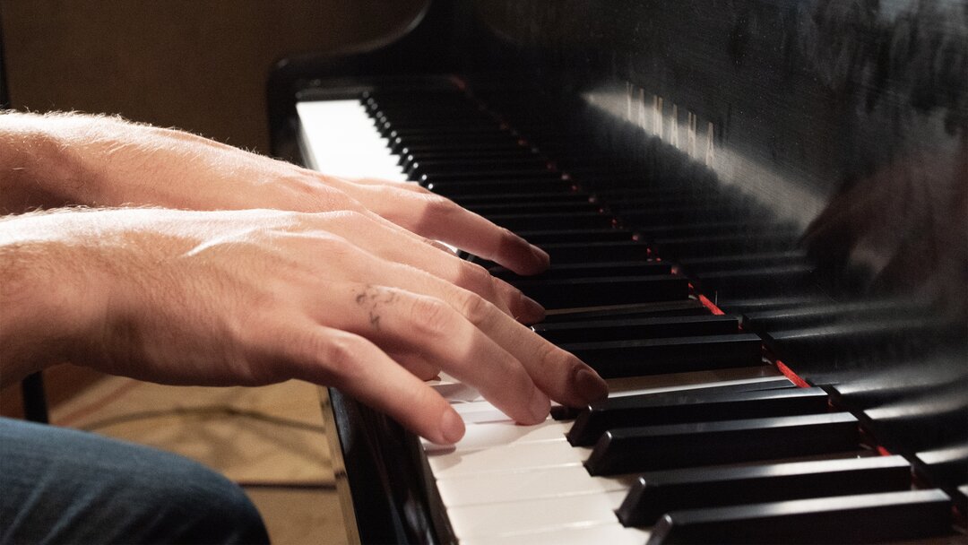 Close-up of hands on a piano