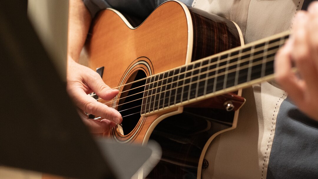 Close-up of a finger-picked acoustic guitar