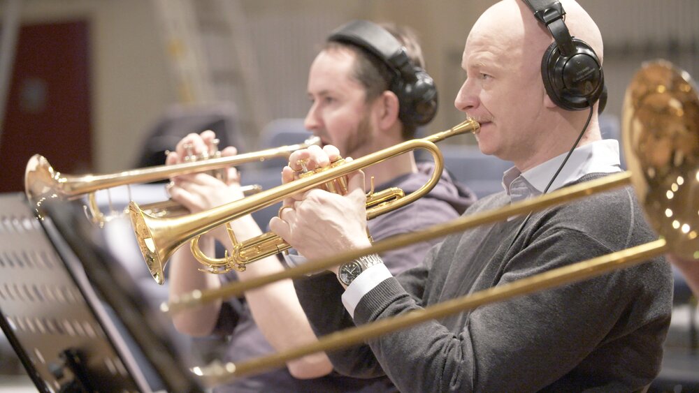 A row of seated trumpet players