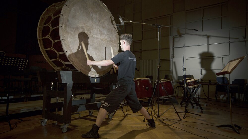 A man recording a giant taiko drum for the Metropolis Ark 3 sample library