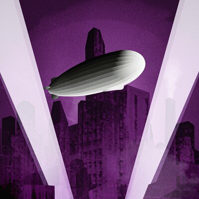 A dirigible floating through spotlights making a roman numeral 5