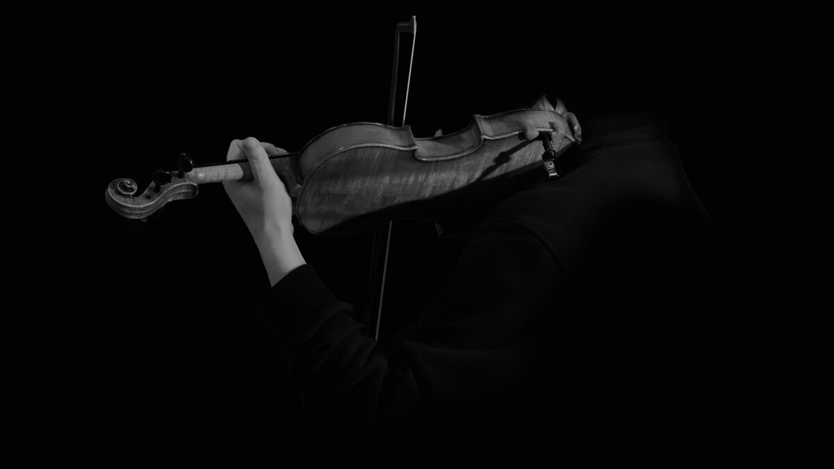 A high-contrast image of a solo violin being played